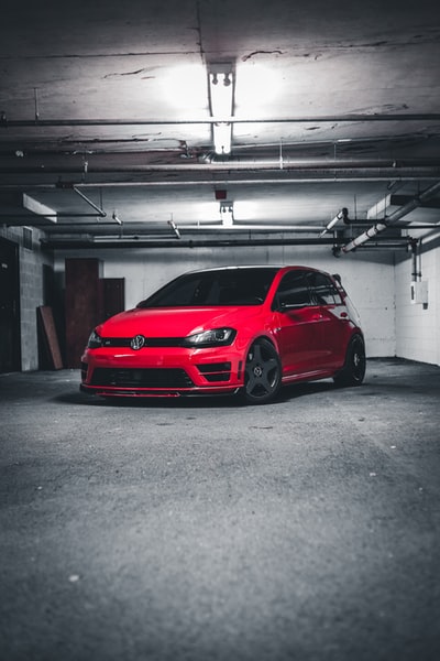 A red car parked in the garage
